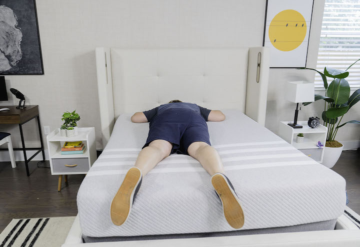 a man sleeps on his stomach on the Leesa mattress