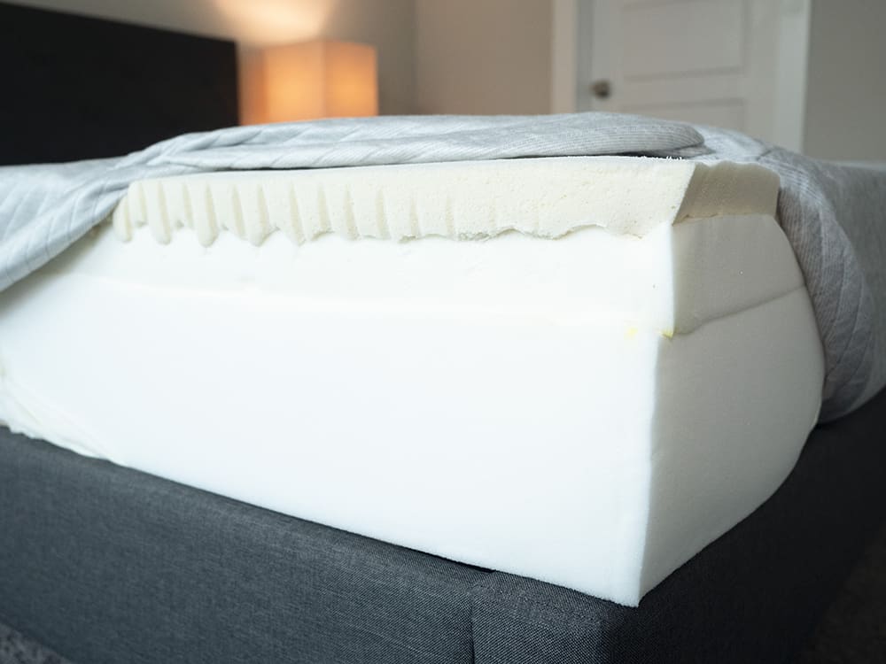 A bed is opened to show its components.