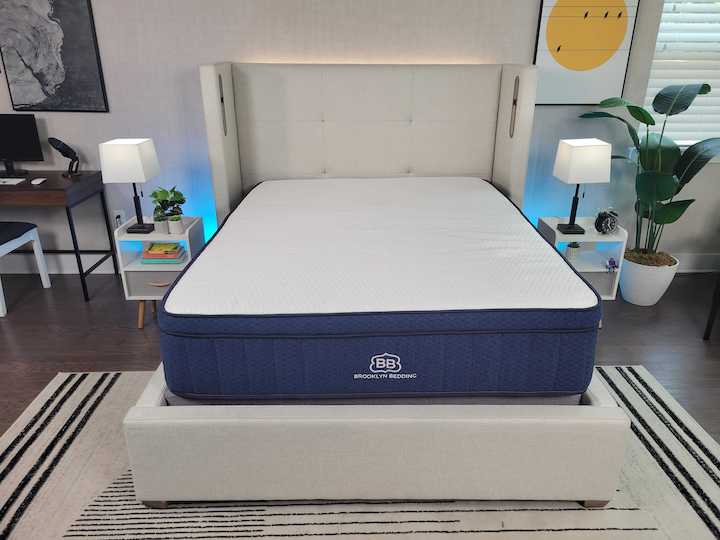 the Aurora Luxe mattress sits on a bed frame