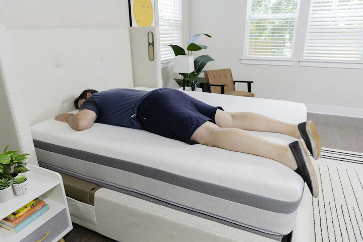 a man sleeps on his stomach on the Helix Plus mattress