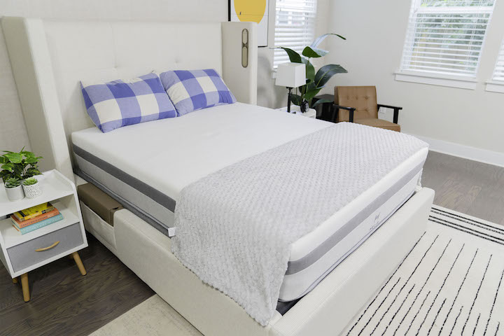 the Helix Plus mattress sits on a bed frame