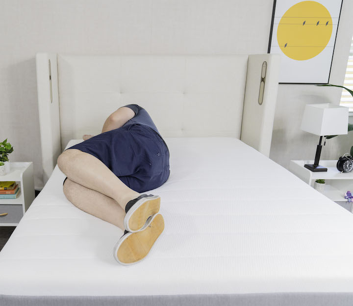 a man sleeps on his side on the Helix Plus mattress
