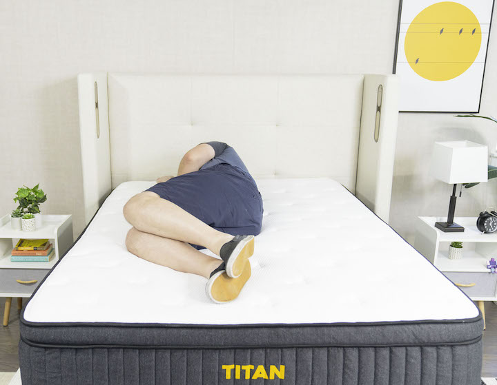 a man sleeps on his side on the Titan Plus mattress