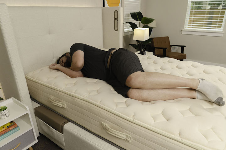 A man sleeps on his side on the Bear Natural mattress
