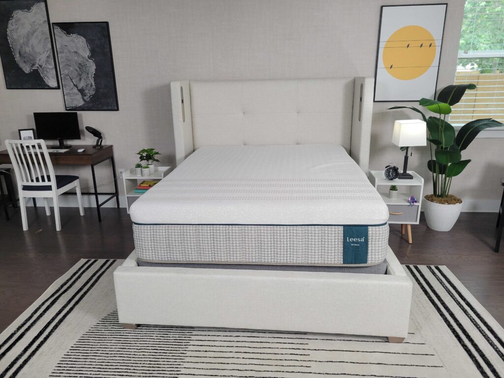 the Leesa Reserve mattress sits on a bed frame in a bedroom