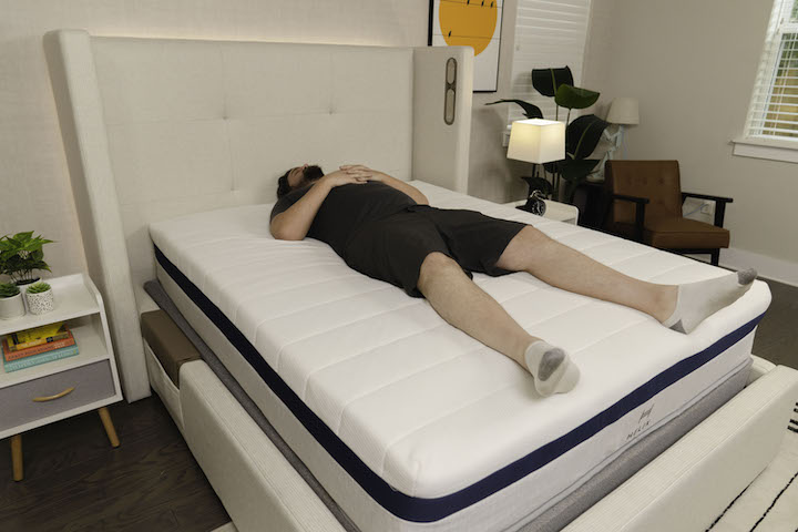 a man sleeps on his back on the Helix Midnight mattress