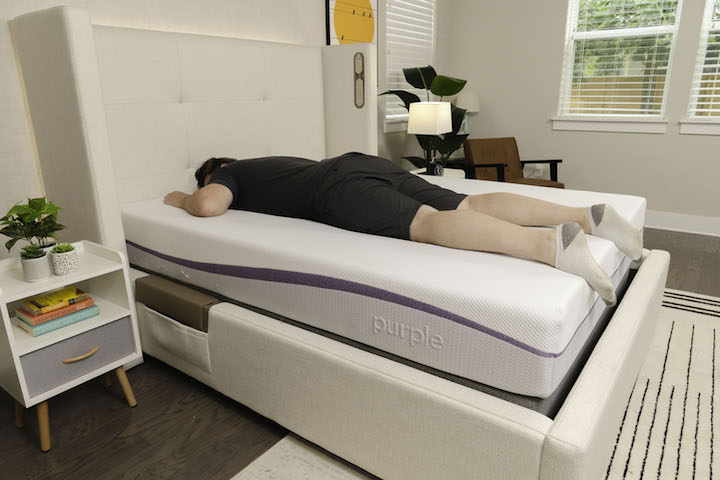 a man sleeps on his stomach on the Purple Original mattress
