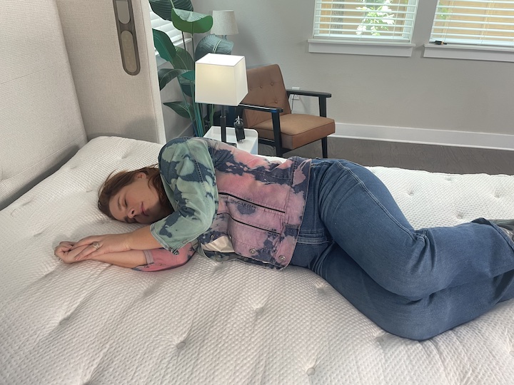 a woman sleeps on her side on the PlushBeds Signature Bliss mattress