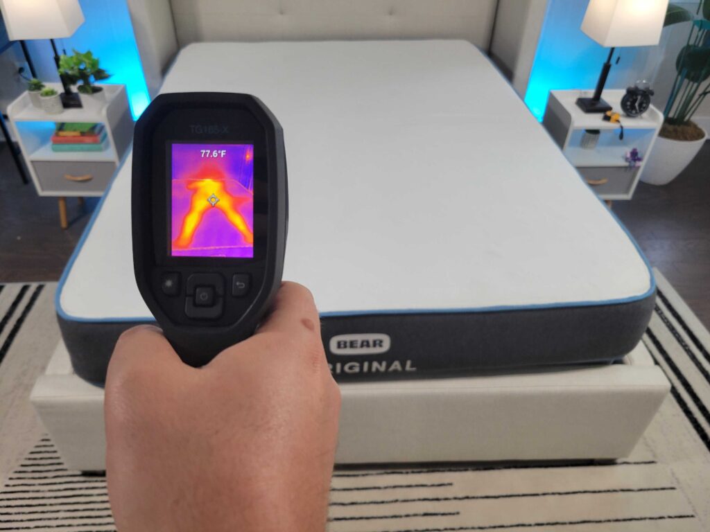Man aiming thermal camera at Bear Original mattress to measure temperature after someone rested on the bed