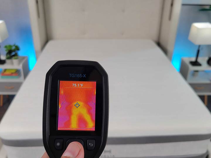 An image of a temperature gun aimed at a mattress. On the screen, it reads 75.1 F