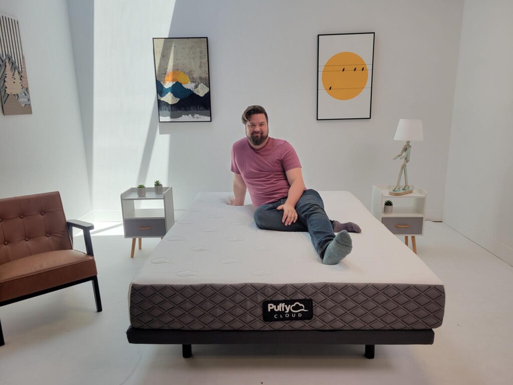 man sitting on Puffy Cloud Mattress and looking at the camera