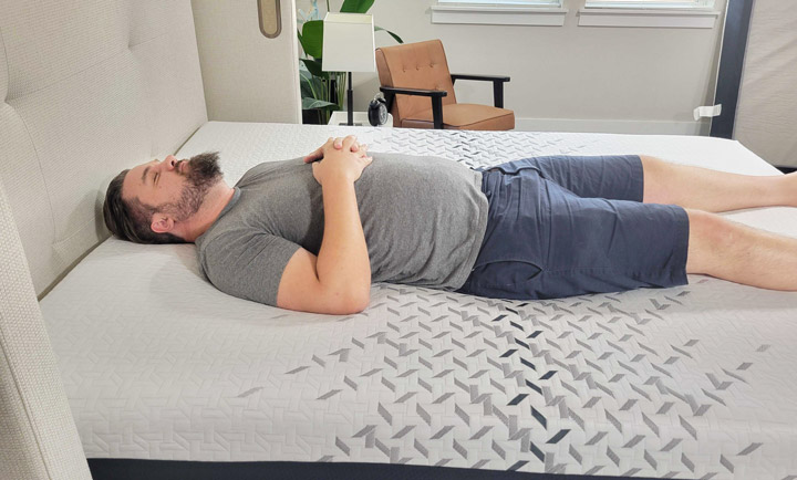 A man sleeps on his back on the Nectar Luxe mattress