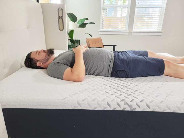 An image of Marten sleeping on his back while on top of the Nectar Premier Mattress