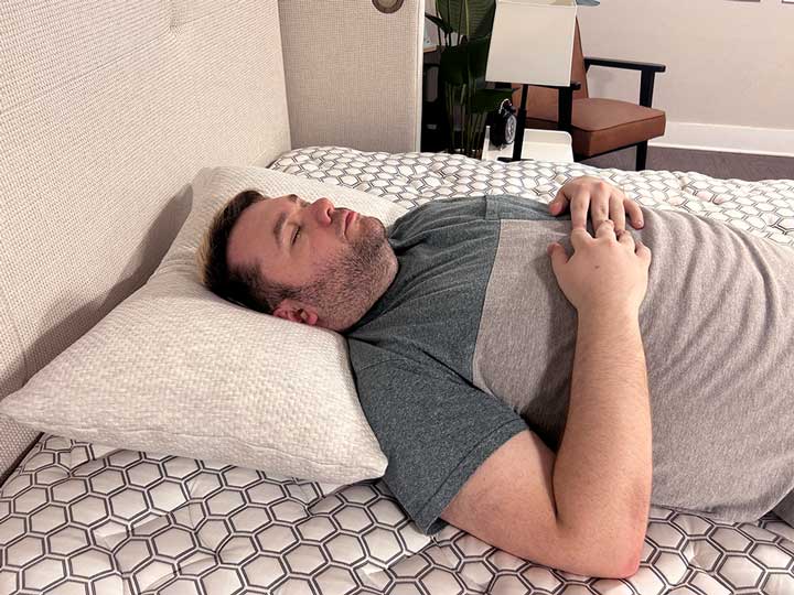 An image of a man sleeping on his back with the Bear Talalay Latex Pillow.