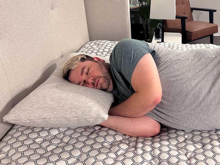 An image of a man sleeping on his side using the Bear Talalay Latex Pillow