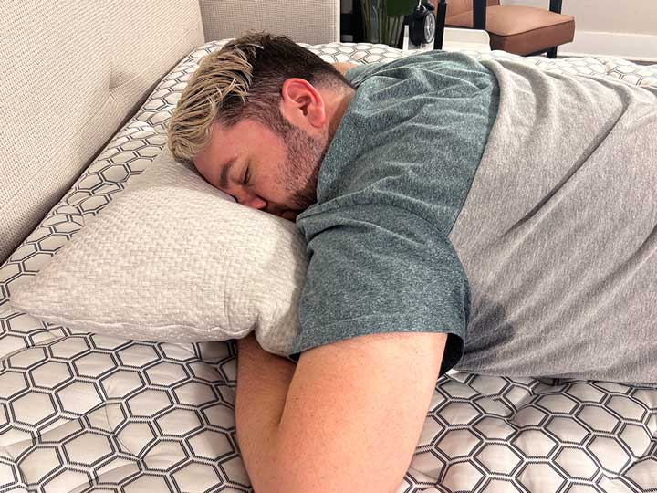 An image of a man sleeping on his stomach with the Bear Talalay Latex Pillow